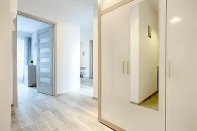 a large mirror in the hallway of a house at Tyzenhauz Apartments Piwna Street in Kraków