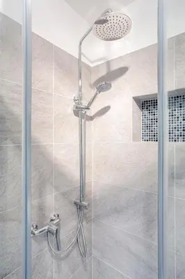 a shower with a glass door in a bathroom at Tyzenhauz Apartments Piwna Street in Kraków
