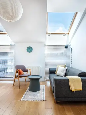 a living room with a couch and a table at Tyzenhauz Apartments Piwna Street in Kraków