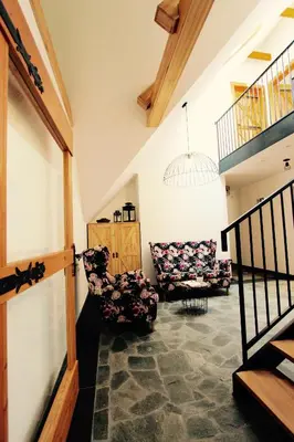 a living room with two chairs and a staircase at KOŃSKA GÓRKA Agroturystyka in Rabka