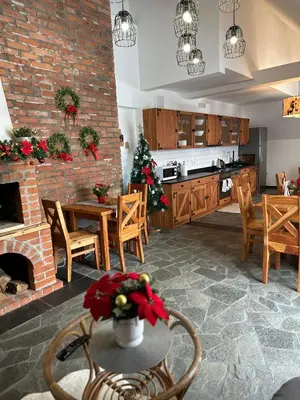 a kitchen and dining room with a christmas tree at KOŃSKA GÓRKA Agroturystyka in Rabka