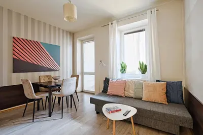 a living room with a couch and a table at Urban Nest Apartments Szewska 21 in Kraków