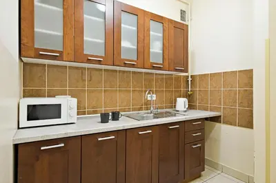 a kitchen with a microwave and a sink at Urban Nest Apartments Szewska 21 in Kraków