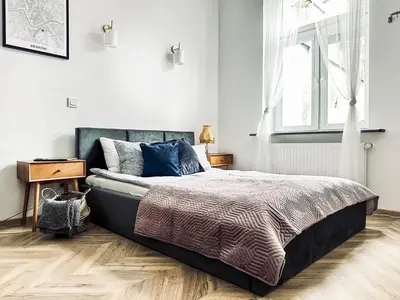 a bedroom with a large bed and a window at Monkeyland - unique apartment in Old Podgorze in Kraków