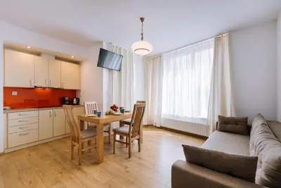 a living room with a couch and a table at ApartmentPrestige - Boulevard in Kraków