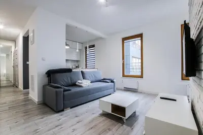 a living room with a couch and a table at ApartmentPrestige - Boulevard in Kraków