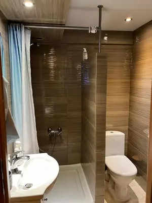a bathroom with a toilet and a sink and a shower at Pod Magnolią in Targanice