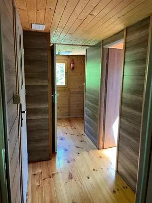 an empty hallway with two doors and wood floors at Pod Magnolią in Targanice