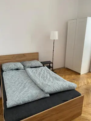 a bedroom with a bed with two pillows on it at Amazing view rooms in Old Town in Kraków