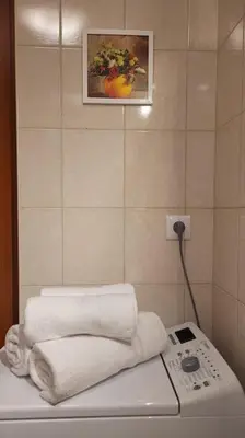 a pile of towels and a phone in a bathroom at Cozy modern Apartment SUNRISE studio 35m2 balcony 3 persons in Kraków