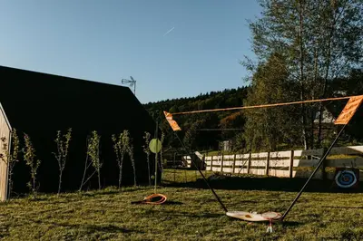 a yard with two surfboards on the grass at Domki pod Kamionna in Laskowa