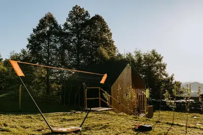 a net in a field next to a shed at Domki pod Kamionna in Laskowa