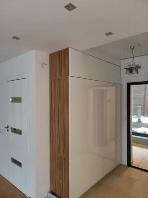 a closet in a room with a wooden cabinet at Amber Hostel Szlak in Kraków