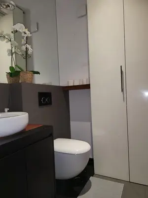 a bathroom with a white toilet and a sink at Amber Hostel Szlak in Kraków