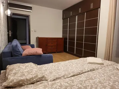 a bedroom with a bed and a dresser and a closet at Amber Hostel Szlak in Kraków