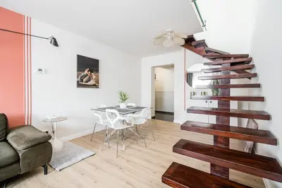 a spiral staircase in a house with wooden floors at Radziwillowska Old Town Deluxe Apartment WAWELOFTS in Kraków