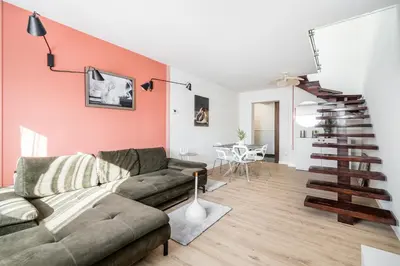 a living room with a couch and a table at Radziwillowska Old Town Deluxe Apartment WAWELOFTS in Kraków