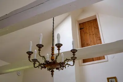 a chandelier hanging from a ceiling in a room at Morowo chałupa in Czchów