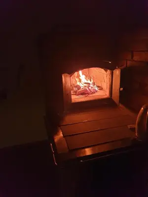 a brick oven with a fire in it at Morowo chałupa in Czchów
