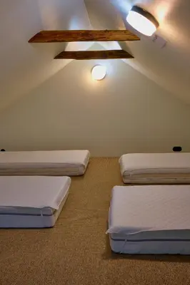 three beds in a room with a ceiling at Morowo chałupa in Czchów