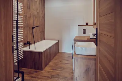a bathroom with a bath tub and a sink at WieliczkaHome 1st floor + garden + parking in Wieliczka