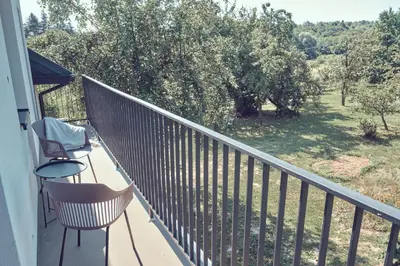 a balcony with chairs and a view of a yard at WieliczkaHome 1st floor + garden + parking in Wieliczka