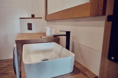 a bathroom with a white sink in a room at WieliczkaHome 1st floor + garden + parking in Wieliczka