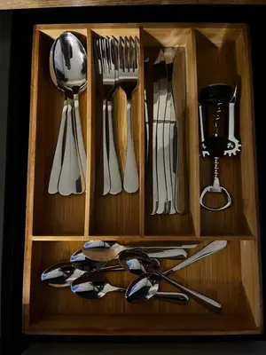 a wooden drawer with utensils in it at Komfortowy Apartament w centrum in Jaworzno