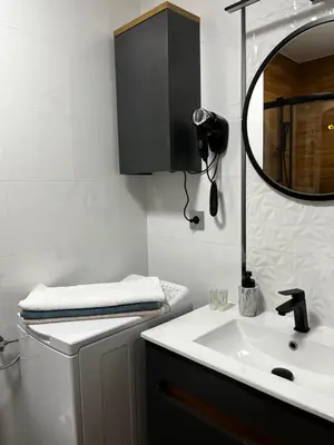 a bathroom with a sink and a mirror at Komfortowy Apartament w centrum in Jaworzno