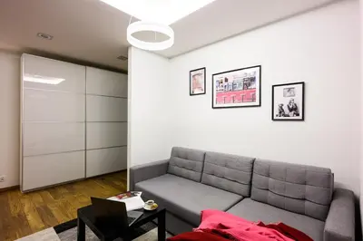 a living room with a couch and a table at Native Apartments Masarska 8/5 in Kraków