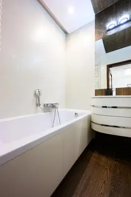 a white bathroom with a tub and a sink at Native Apartments Masarska 8/5 in Kraków