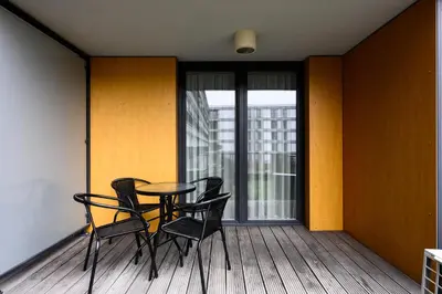 a dining room with chairs and a table on a balcony at Native Apartments Masarska 8/5 in Kraków
