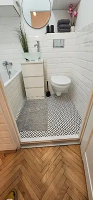 a bathroom with a toilet and a sink at Apartamenty Lenart in Kraków