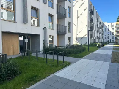 an empty sidewalk in front of a building at Tauron Arena Apartment with Garage - Kraków Lema in Kraków