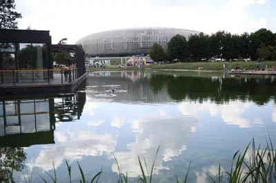 a large body of water with a building in the background at Tauron Arena Apartment with Garage - Kraków Lema in Kraków