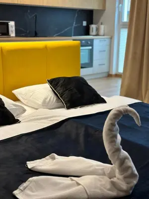 a bedroom with two beds with a swan on them at Tauron Arena Apartment with Garage - Kraków Lema in Kraków