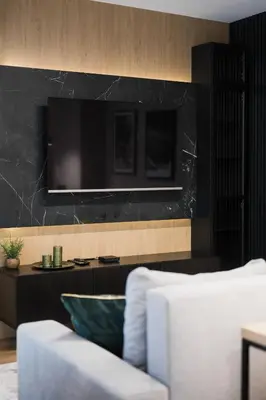 a living room with a couch and a television on a wall at Tauron Arena Apartment with Garage - Kraków Lema in Kraków