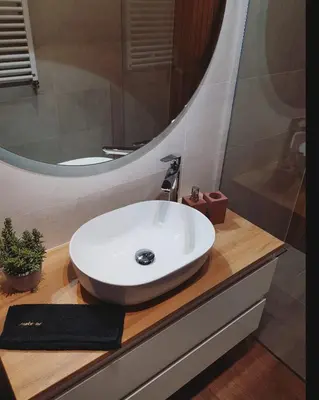 a bathroom with a white sink and a mirror at Złota Nowa Huta in Kraków