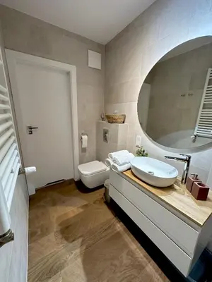 a bathroom with a sink and a toilet and a mirror at Złota Nowa Huta in Kraków