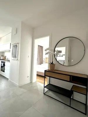 a living room with a mirror and a table at Złota Nowa Huta in Kraków
