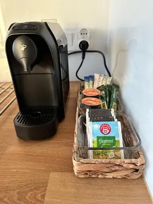 a toaster sitting on a table next to a basket of food at Złota Nowa Huta in Kraków