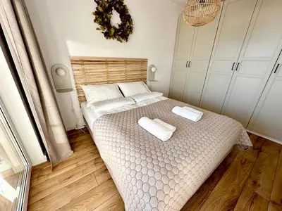 a bedroom with a bed with two towels on it at Złota Nowa Huta in Kraków