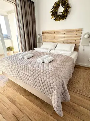 a bedroom with a large bed with two pillows on it at Złota Nowa Huta in Kraków