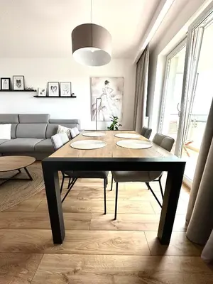 a living room with a table and a couch at Złota Nowa Huta in Kraków
