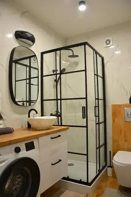 a bathroom with a sink and a washing machine at Apartament na wynajem 32 m2 in Bochnia