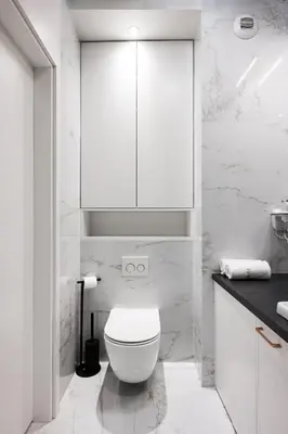 a white bathroom with a toilet and a cabinet at Salomea apartments Kraków, Stary Kazimierz, Tauron arena in Kraków