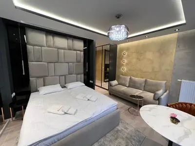 a bedroom with a bed and a couch and a table at Salomea apartments Kraków, Stary Kazimierz, Tauron arena in Kraków