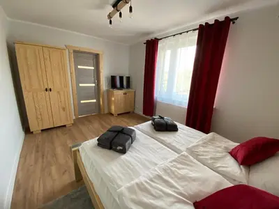a bedroom with a bed with two bags on it at Willa Pod Wyciągiem in Spytkowice
