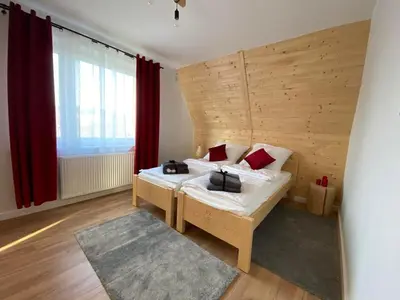 a bedroom with a bed and a large window at Willa Pod Wyciągiem in Spytkowice