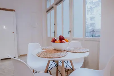 a white table with a bowl of fruit on it at Old Town WAWEL Premium Apartment - 60m2 in Kraków